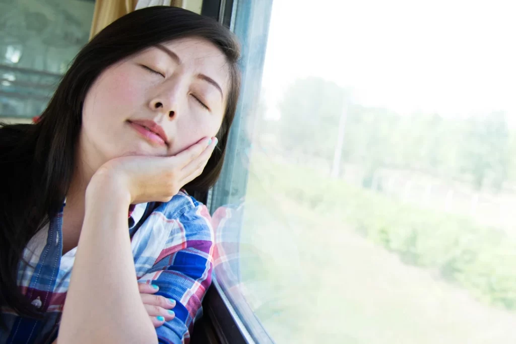 Girl taking a cat nap while travelling.