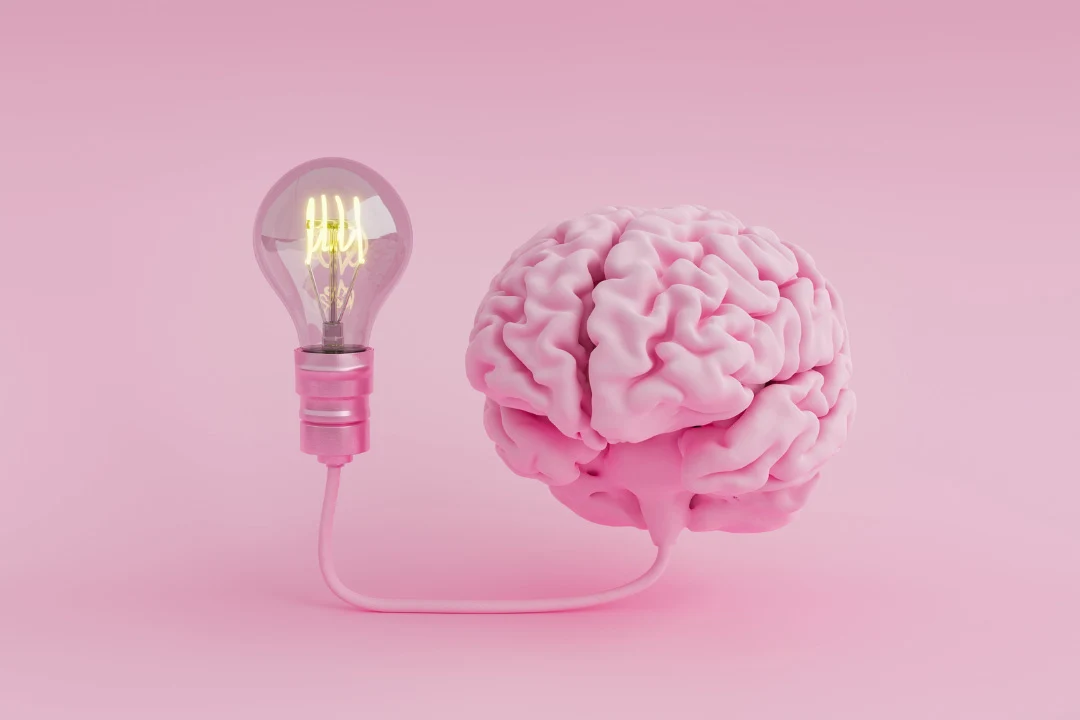 brain pill reviews, brain and bulb in pink shadow with pink background