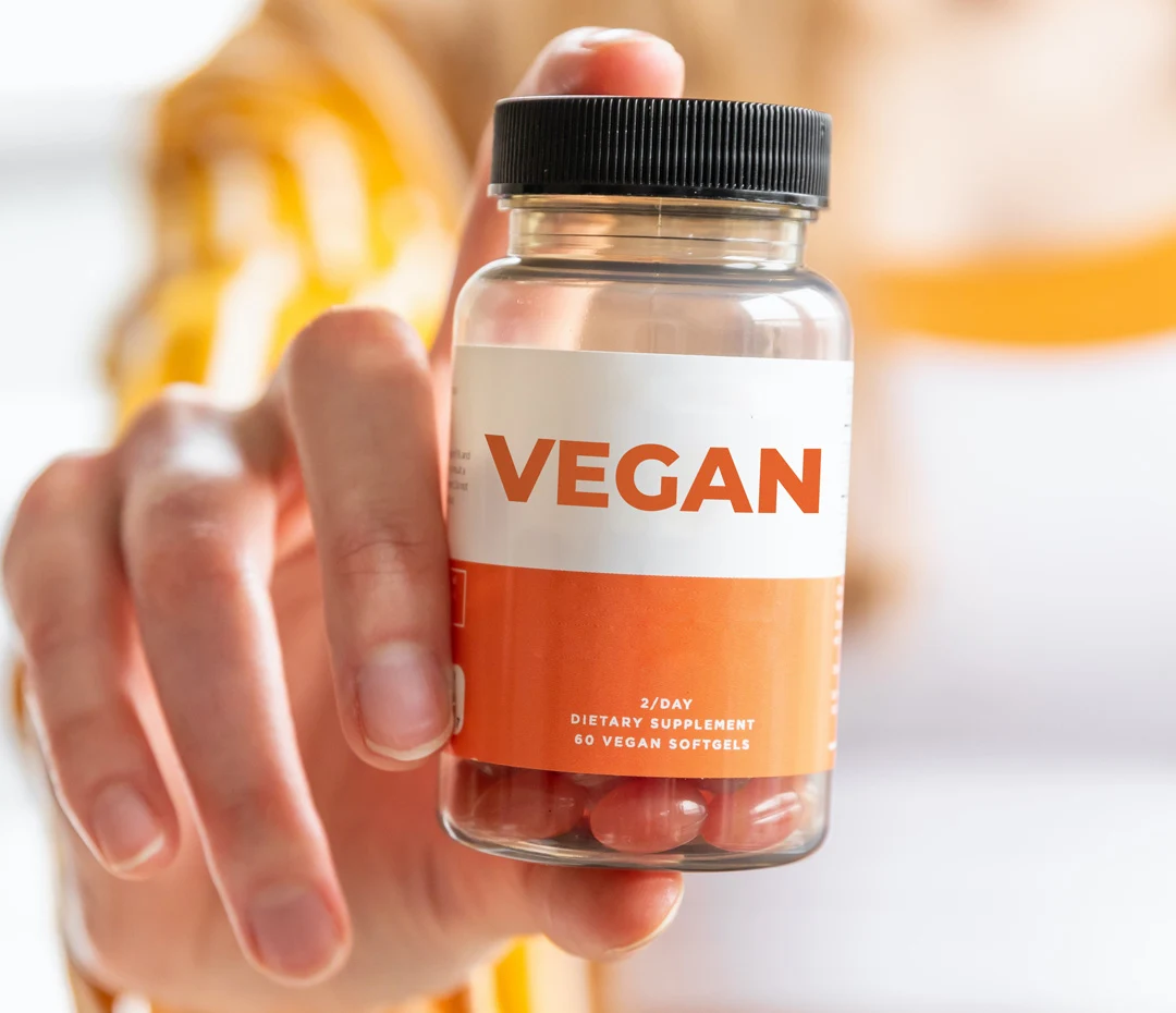 vegan probiotic supplements in girl hand