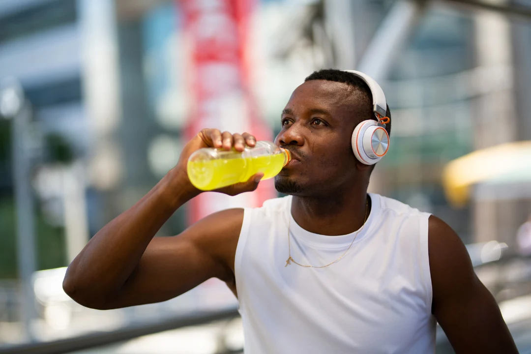 young athlete drinking electrolyte drink