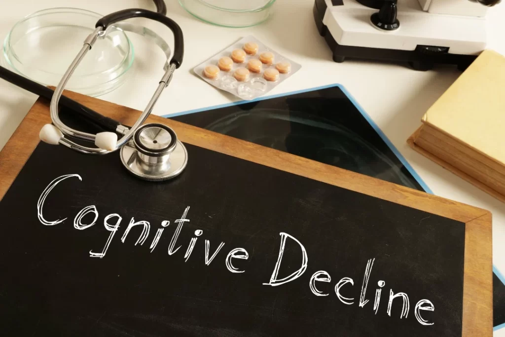 Cognitive Decline is written on a slate with a white marker with a stethoscope.