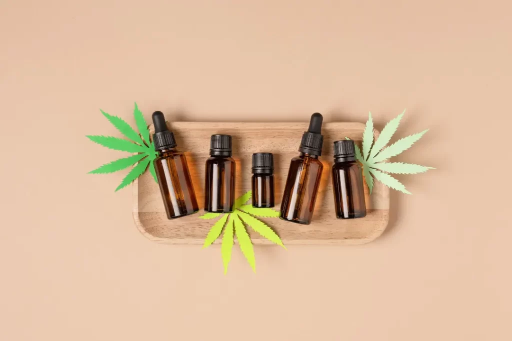 CBD Leaves and CBD oil on a wooden table. 