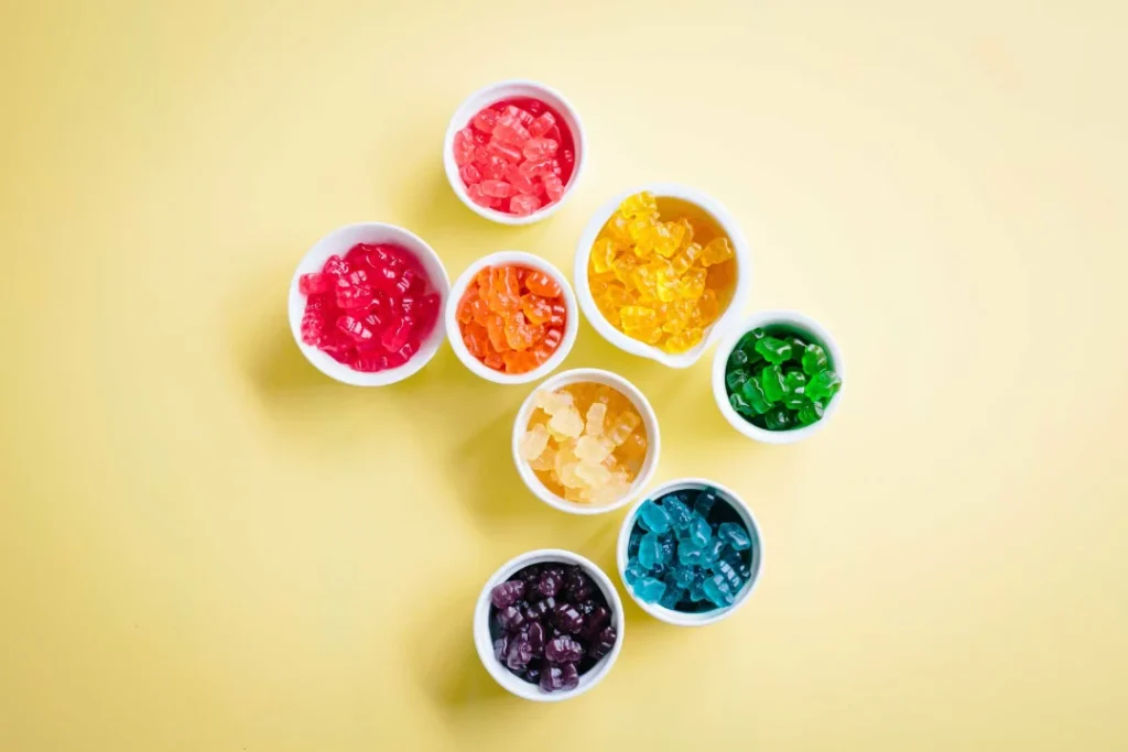 Different flavors of gummies are placed in different bowls.