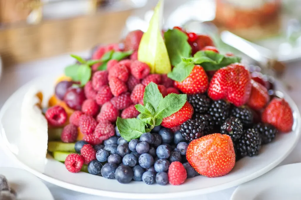 Organic and fresh fruits in white plate. 