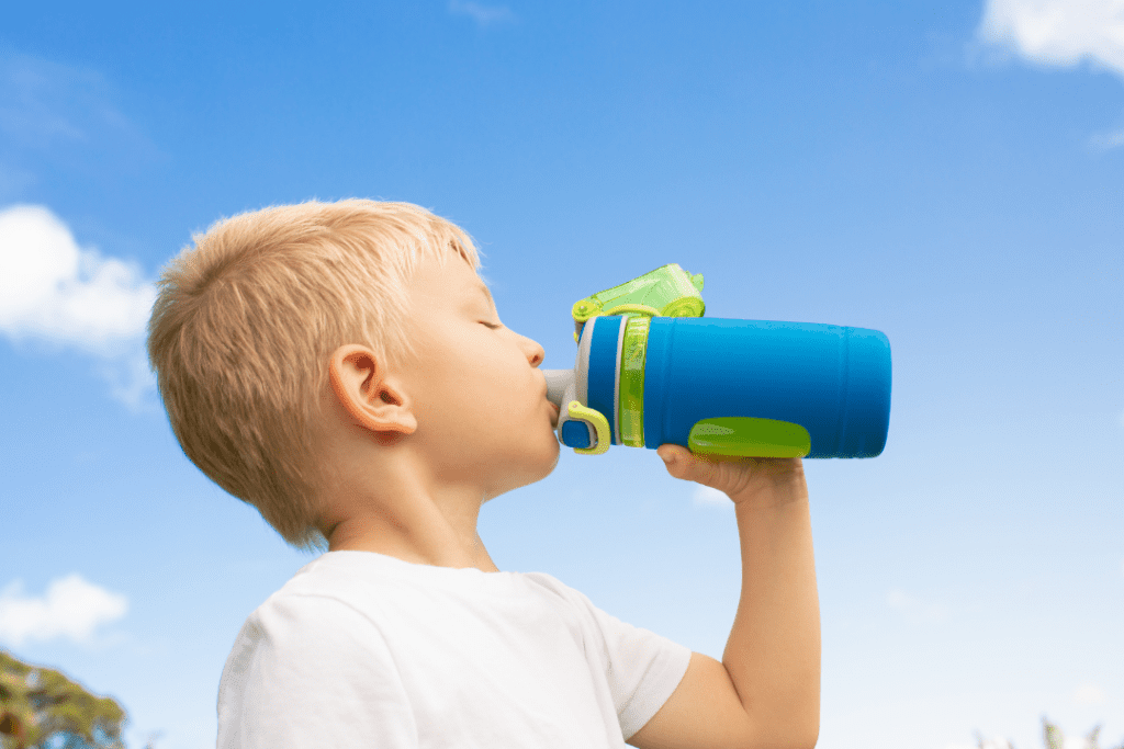 Little child drinking energy drink
