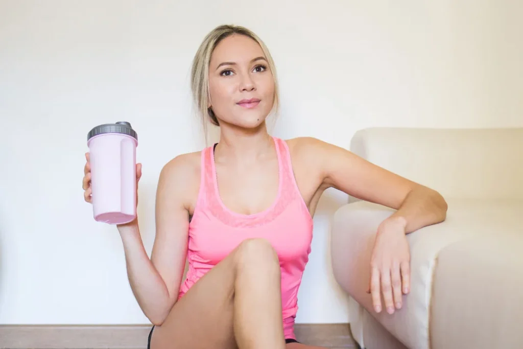 A young lady using protein supplements . 
