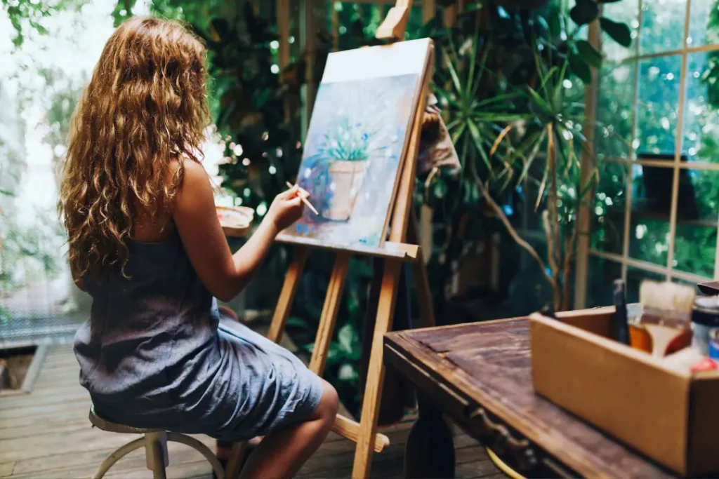 A girl is painting. 
