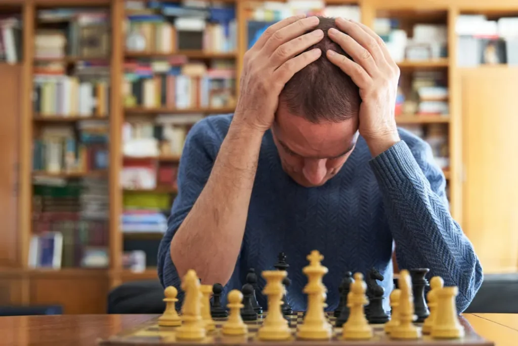 A man worried while playing chess. 
