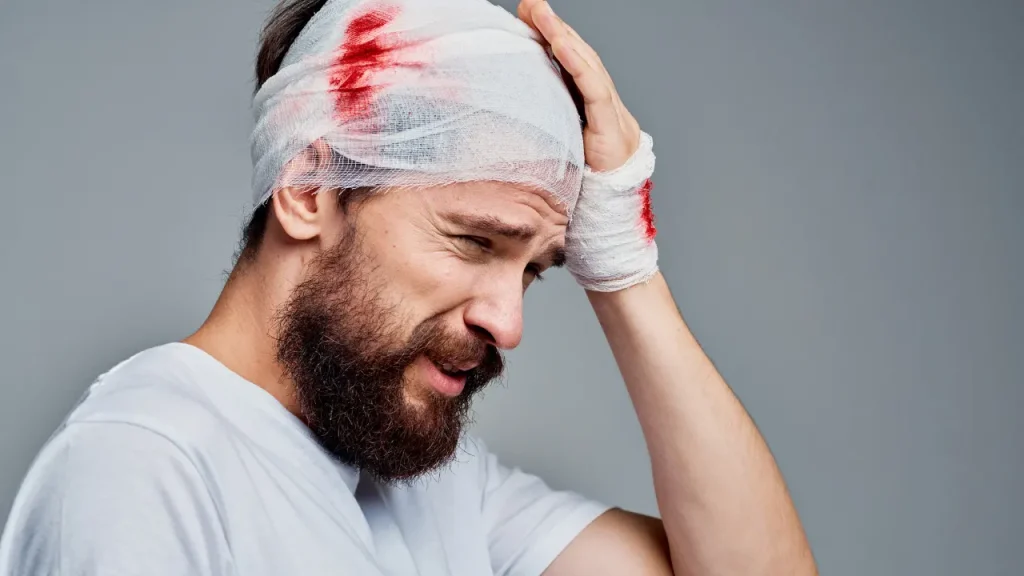 Man having bandage on his head. 
