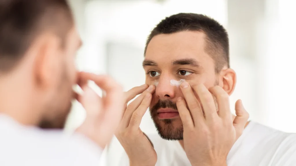 men applying eye cream